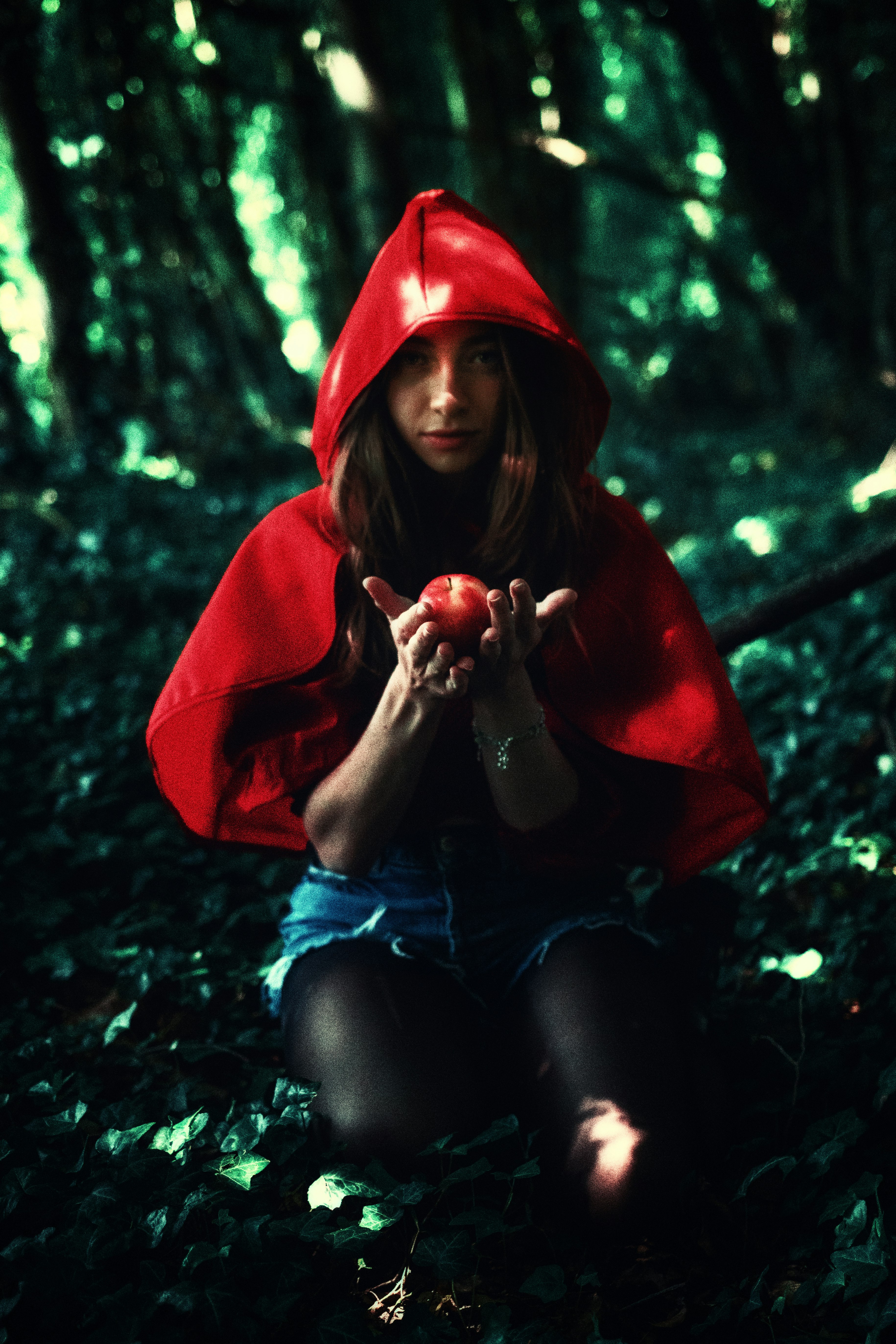 woman in red hoodie sitting on ground